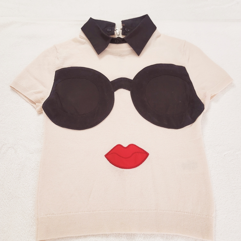 Beige Top with Black Collar and Graphic Design